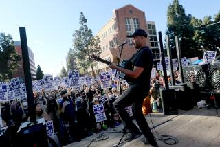 LOS ANGELES, CALIF. - DEC. 14, 2022. Musician and labor activist Tom Morello performs for striking University of California academic workers and faculty gathered on the campus of UCLA, where the UC Board of Regents met on Wednesday, Dec. 14, 2022. The strikers, made up largely of postdcotoral employees and academic researchers, are demanding bettter pay and benefits. (Luis Sinco / Los Angeles Times)