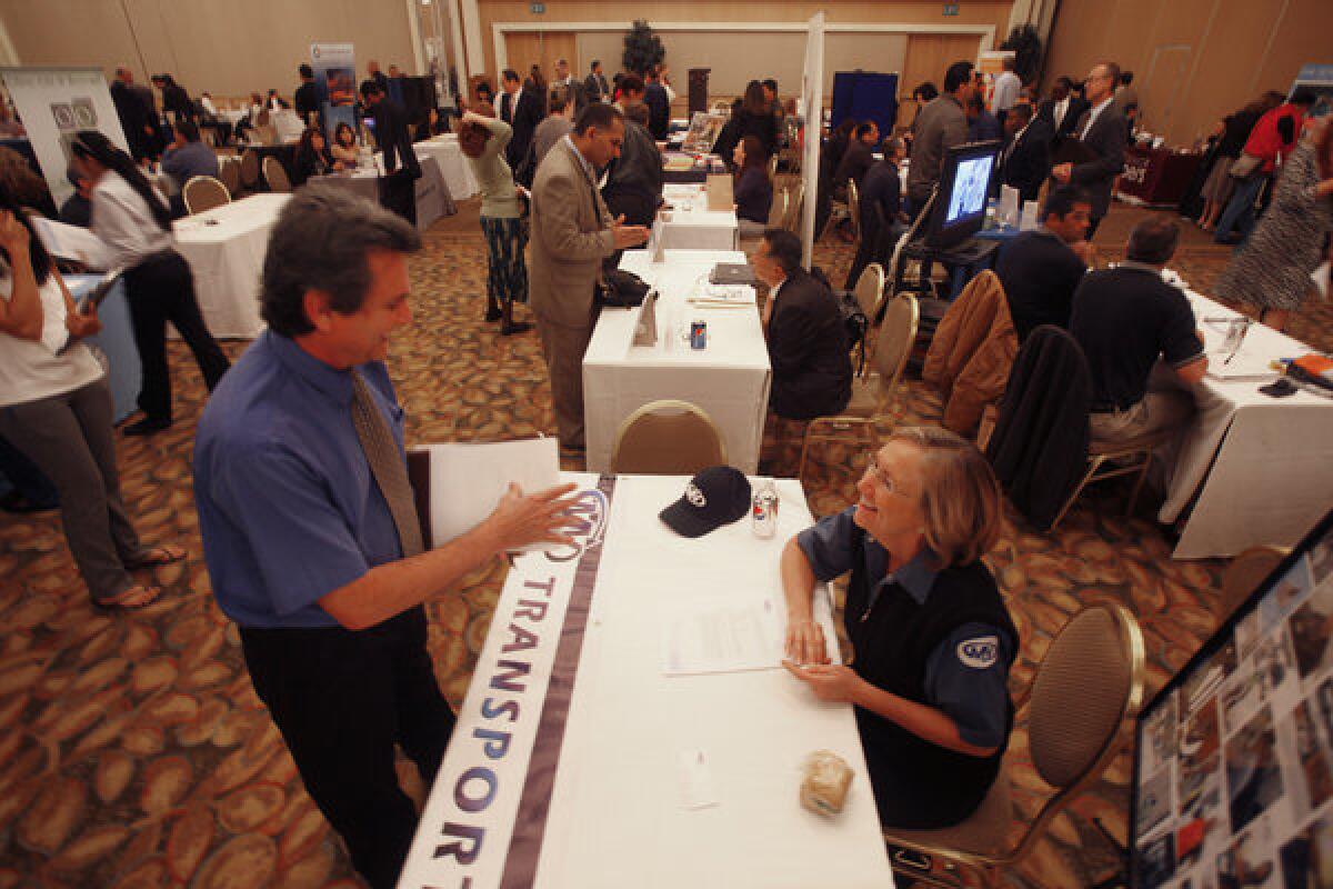 Hundreds of workers seeking jobs attend the Orange County Job Fair at the Hyatt Regency Hotel in Irvine.