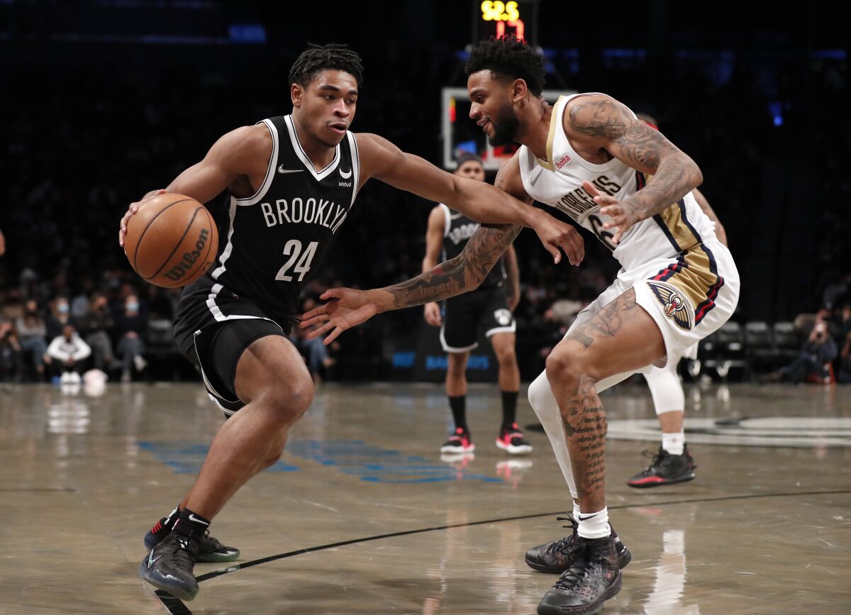 Brooklyn Nets guard Cam Thomas (24) drives to the basket to the basket against New Orleans Pelicans guard Nickeil Alexander-Walker (6) during the first half of an NBA basketball game, Saturday, Jan. 15, 2022, in New York. (AP Photo/Noah K. Murray)