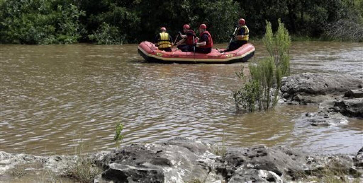 A Schertz Fire Department team searches for the third victim of flooding near San Antonio last weekend.