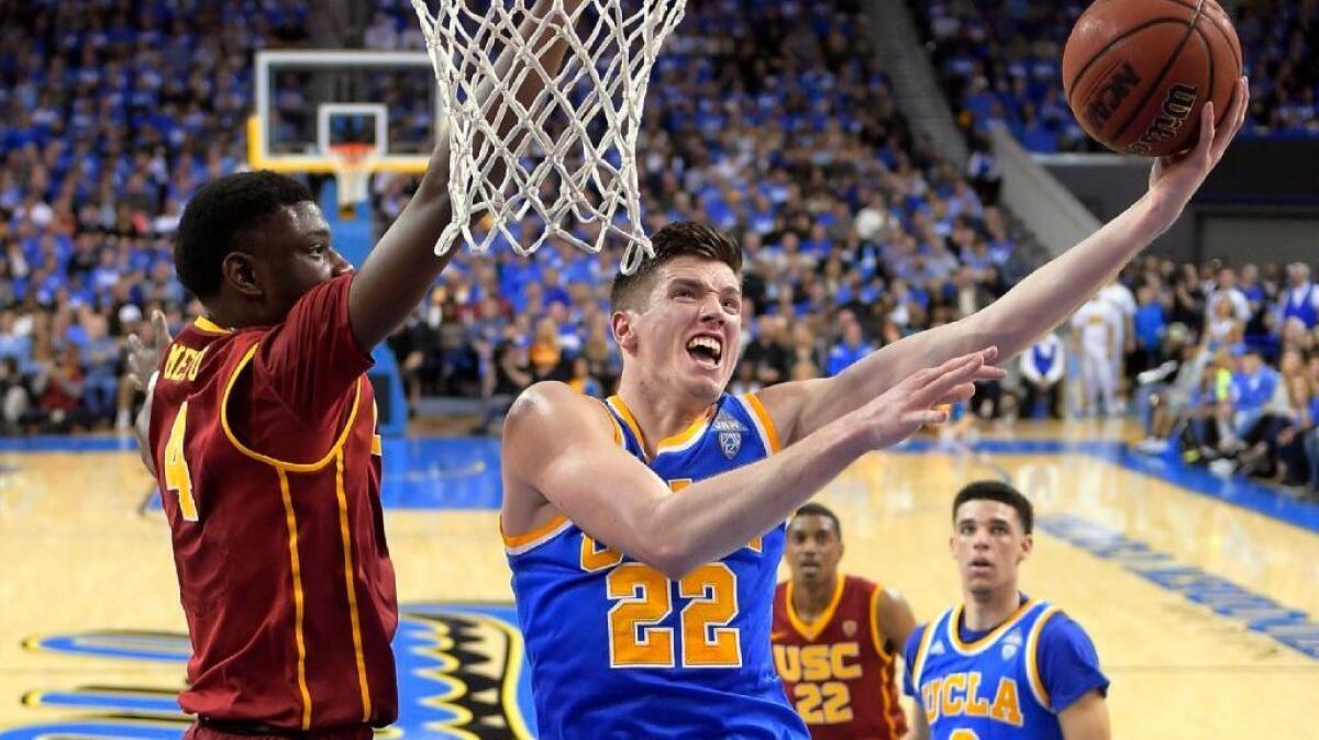 UCLA forward TJ Leaf, right, shoots as USC forward Chimezie Metu defends during the first half of a game at Pauley Pavilion on Feb. 18.