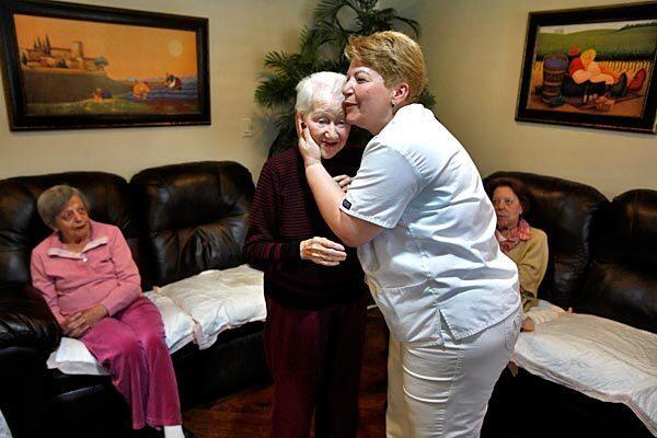 Raya's Paradise operates several boarding homes that care for people with Alzheimer's disease and other ailments of old age. But when they wanted to build a facility in a Hollywood neighborhood, homeowners balked. At one of Raya's existing facilities in West Hollywood, Hasmik Nazaryan embraces patient Evelyn Labonte, as Elise Christoffersen looks on at left. They were celebrating the birthday of a fellow resident. See full story