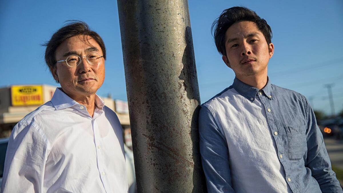 Justin Chon, right, and his father Sang Chon at the corner of Van Ness Avenue and W. Rosecrans Ave., one of the sites where Justin filmed the movie "Gook," about the Korean experience in the LA riots of 1992. (Robert Gauthier / Los Angeles Times)
