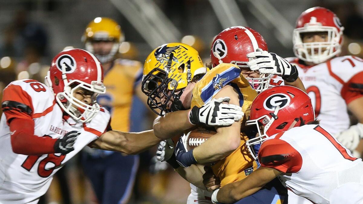 Marina High's Nathan O'Rourke, center, made the All-Big 4 League first team after totaling 135 tackles.