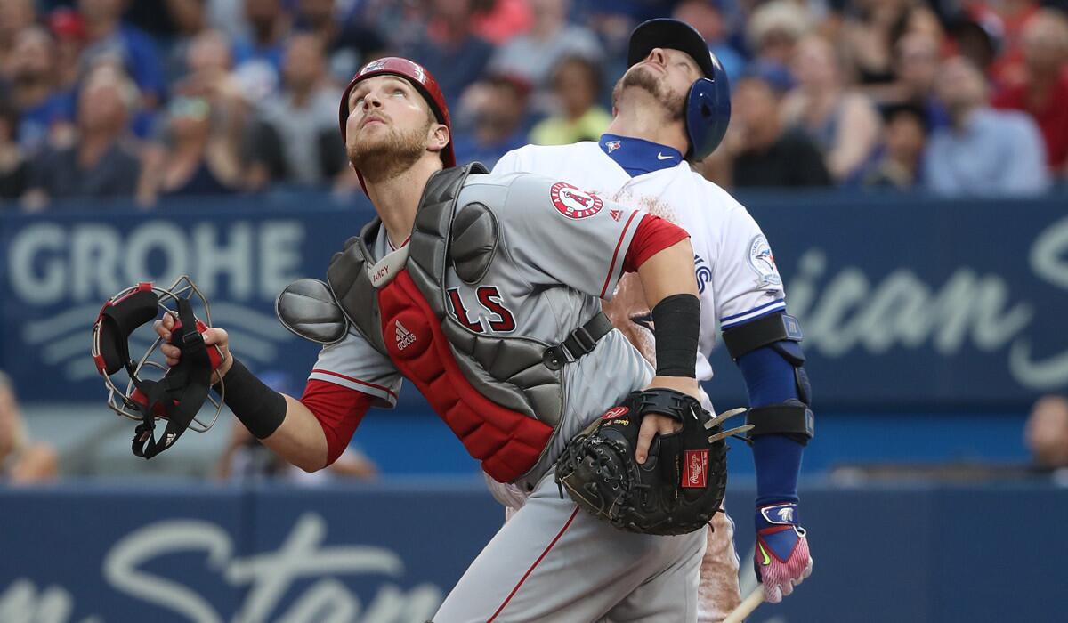Angels catcher Jett Bandy goes after a popout by Toronto's Josh Donaldson, background, in the first inning.