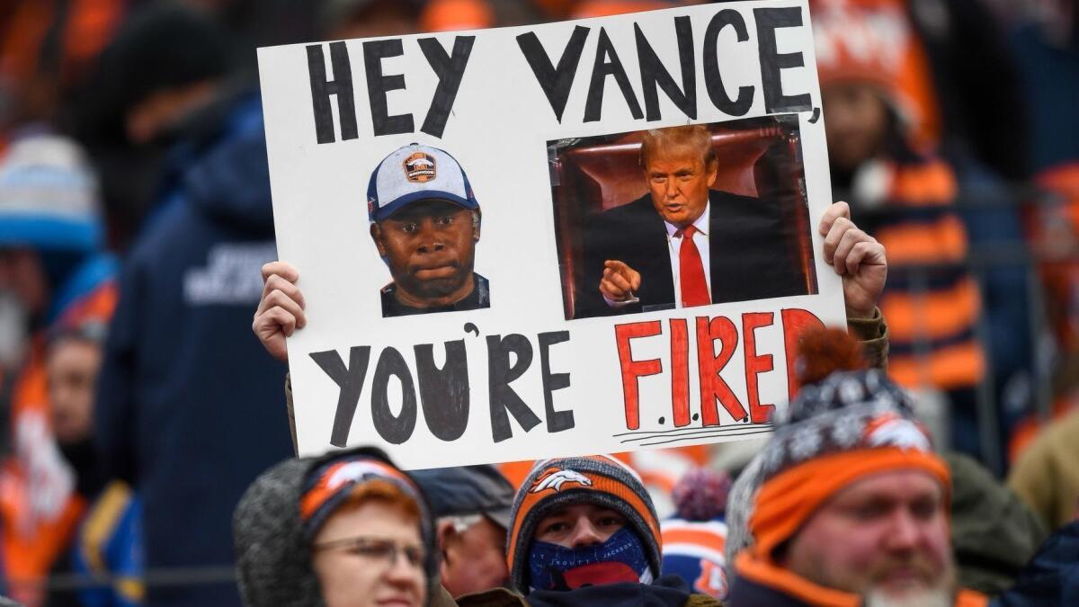 A Denver Broncos fan holds a sign calling for the firing of head coach Vance Joseph during a game against the Rams on Oct. 14 in Denver.