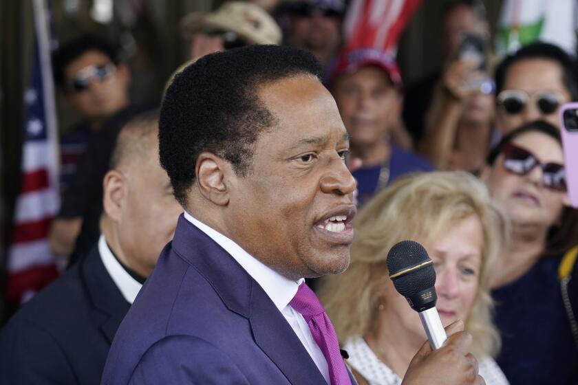 FILE - In this July 13, 2021, file photo, conservative radio talk show host Larry Elder speaks to supporters during a campaign stop in Norwalk, Calif. Four of the high-profile Republican candidates, who are seeking to replace Gov. Gavin Newsom in next months recall election, are heading into their first televised debate, to be held Wednesday, Aug. 4, 2021. Elder and realty tv personality Caitlyn Jenner will not attend the debate. (AP Photo/Marcio Jose Sanchez, File)