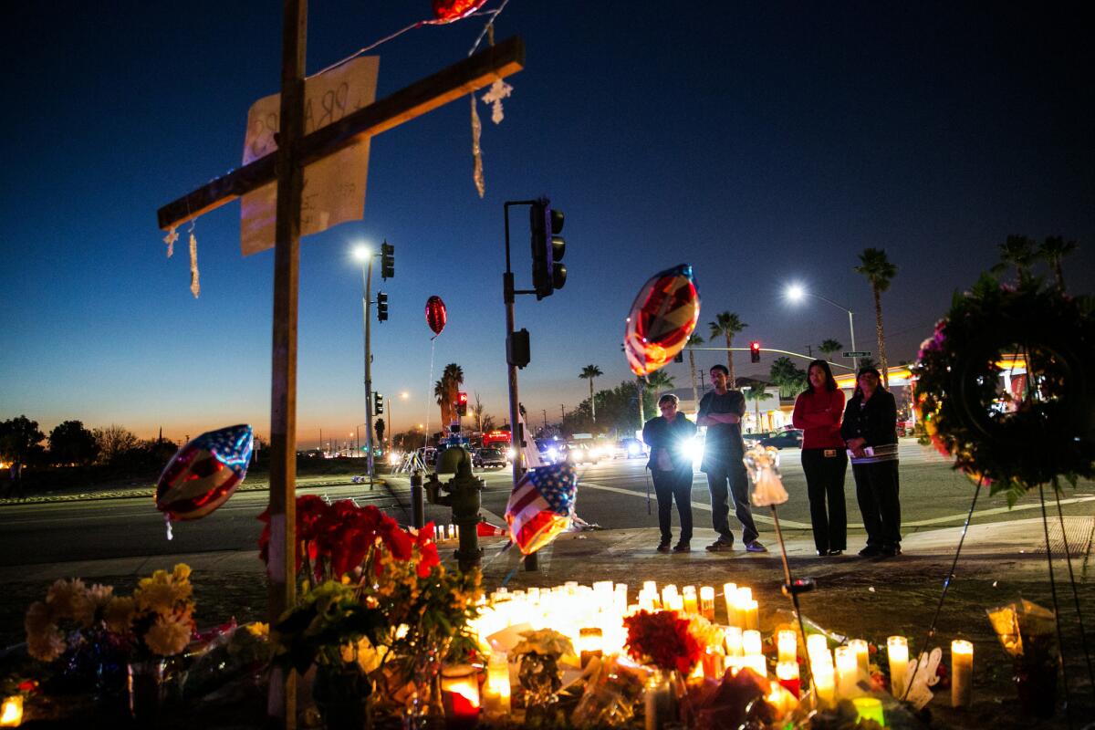 After sunset, people continue to arrive at the memorial site for the victims of the recent mass shootings at the Inland Regional Center in San Bernardino.
