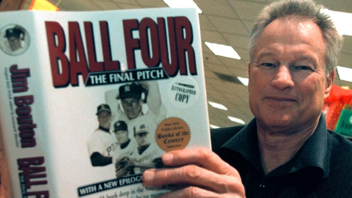 Former New York Yankees pitcher Jim Bouton signs copies of his book "Ball Four: The Final Pitch," on November 27, 2000.