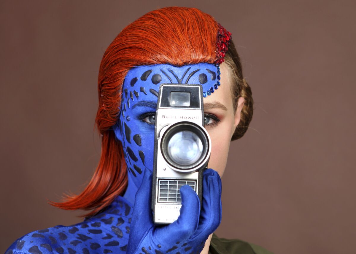 Evy Thomas, dressed as Mystique, poses for a portrait on day one of Comic-Con International on Thursday, July 18, 2019.