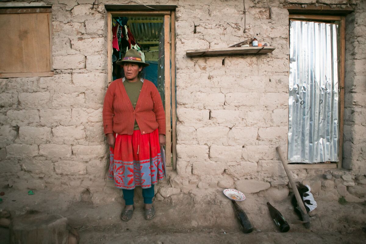 Agustine Llusca Aguilar, 35, the widow of Beto Chahuayllo, outside her house in Arcospampa, Peru.