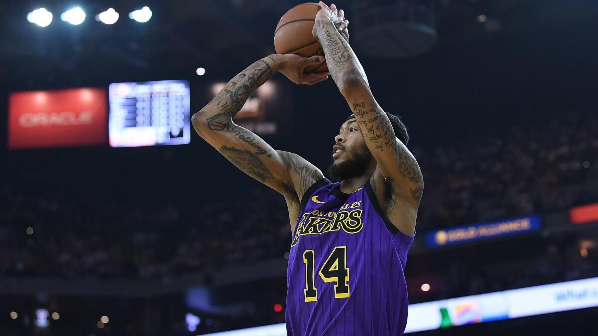 Lakers' Brandon Ingram shoots a three-point shot against the Golden State Warriors during the first half Tuesday in Oakland.