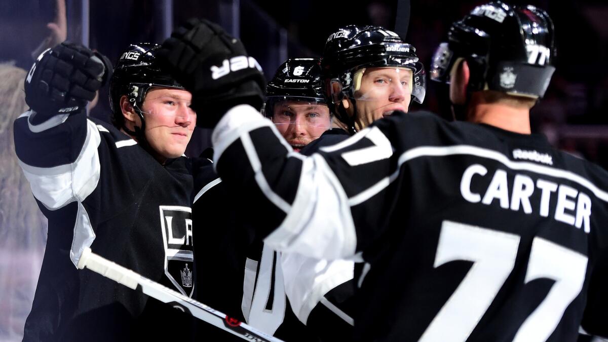 Kings center Tyler Toffoli, left, celebrates his goal against the Sharks in the first period with teammates Jake Muzzin, Christian Ehrhoff and Jeff Carter.