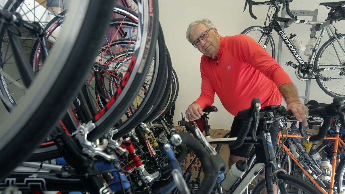 Dr. Daniel Marks of Carlsbad posed with some of 22 bicycles, which he takes turn riding during his thrice-weekly fitness rides.