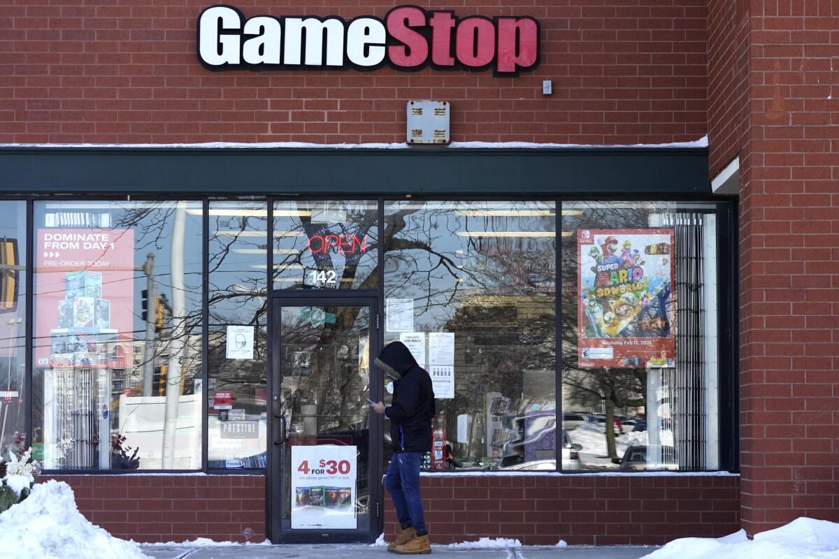 A person stands outside a GameStop store in Vernon Hills, Ill. 