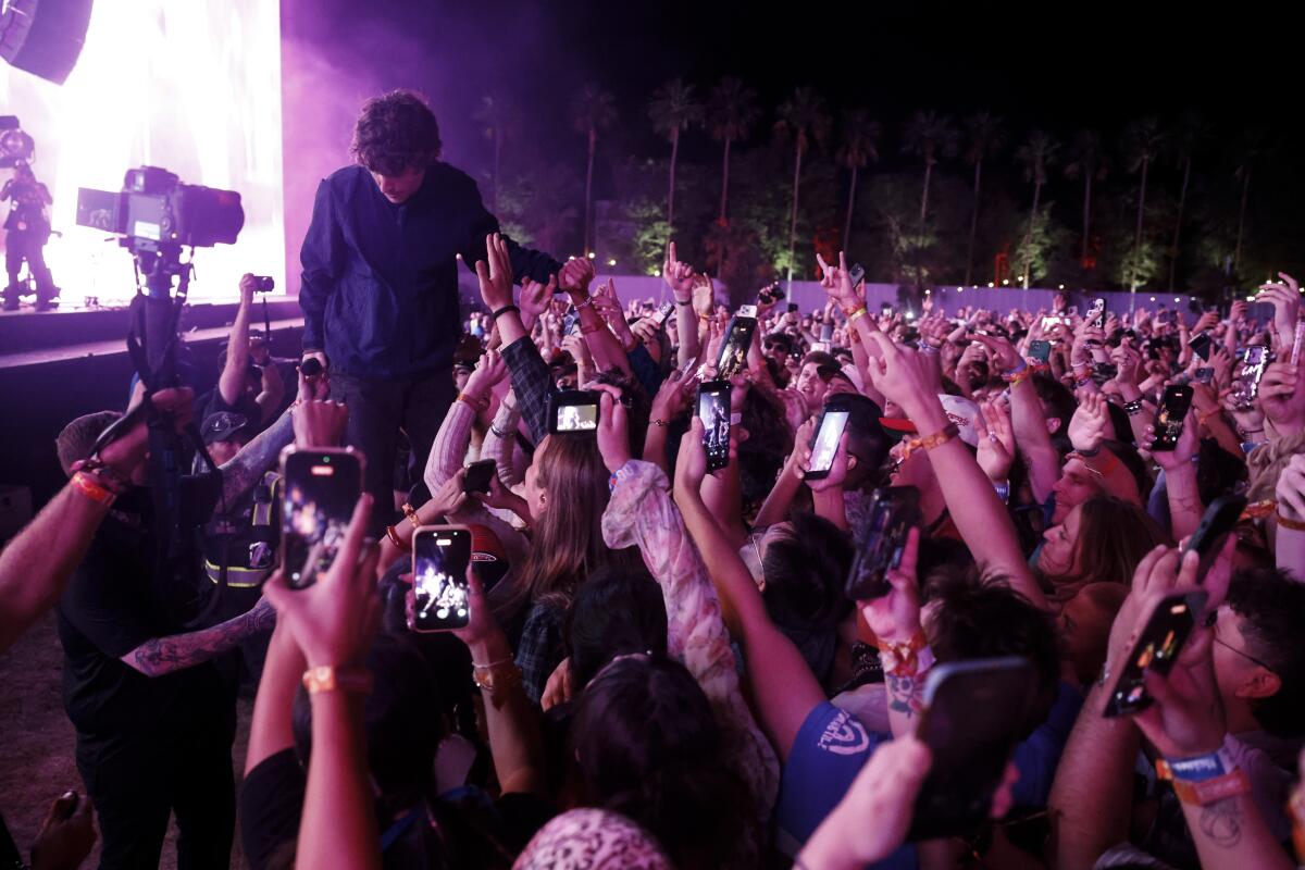 Brendan Yates, lead vocalist of Turnstile, jumps in the crowd