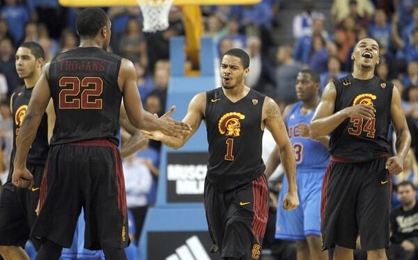 USC guard Jio Fontan (1) celebrates with teammates after their 75-71 victory over UCLA on Wednesday night at Pauley Pavilion.