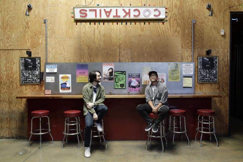 LOS ANGELES, CA - AUGUST 30: Kyle Wilkerson, left, and marketing director Tommy Sugimoto at the closed Bootleg Theater in Los Angeles. Wilkerson has been outspoken about legislation before Congress, the Save Our Stages Act, that would provide direct grants to independent music venues shuttered by COVID-19 like the Bootleg Theater which has been closed since March. Photographed at Bootleg Theater on Sunday, Aug. 30, 2020 in Los Angeles, CA. (Myung J. Chun / Los Angeles Times)