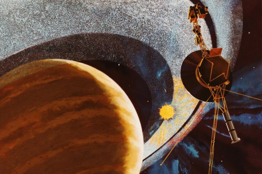 An artist's impression of NASA's Voyager 1 space probe passing behind the rings of Saturn, using cameras and radio equipment to measure how sunlight is affected as it shines between the ring particles. The image was produced in 1977, before the craft was launched, and depicts events due to take place in 1980.