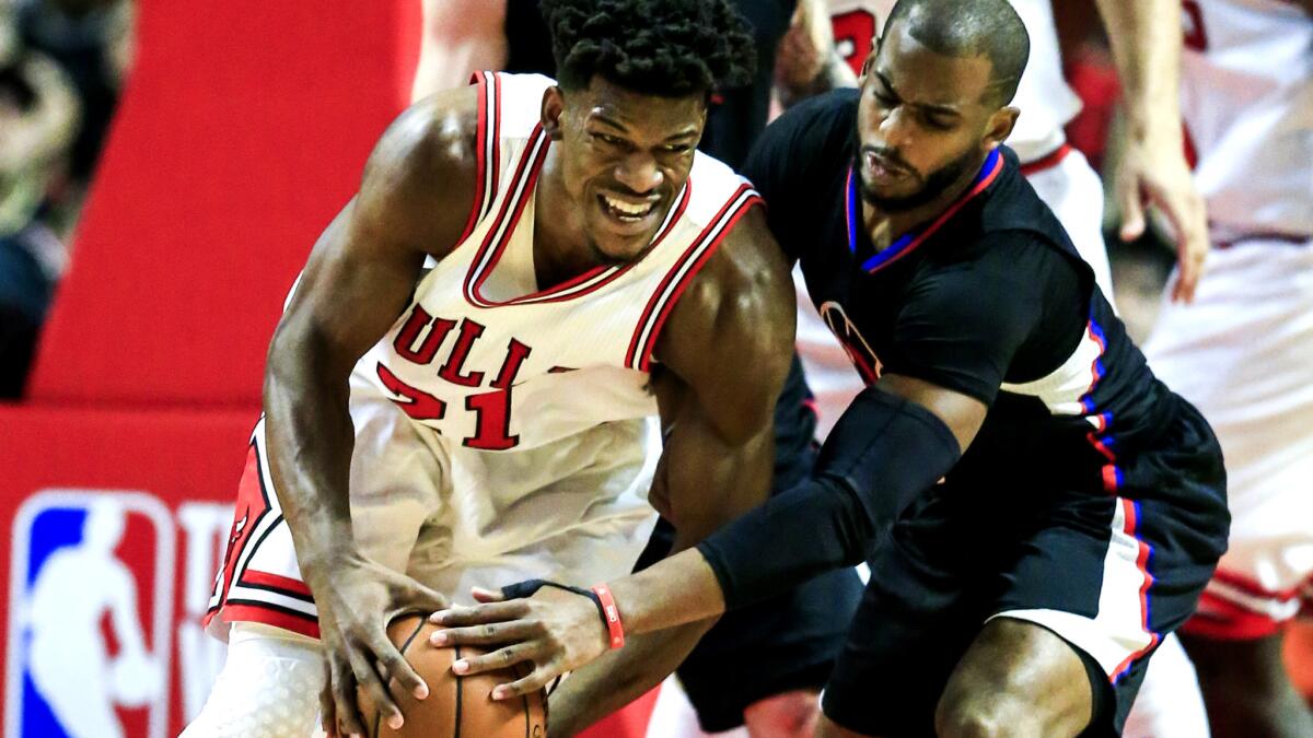 Clippers guard Chris Paul tries to steal the ball from Bulls forward Jimmy Butler during the first half.