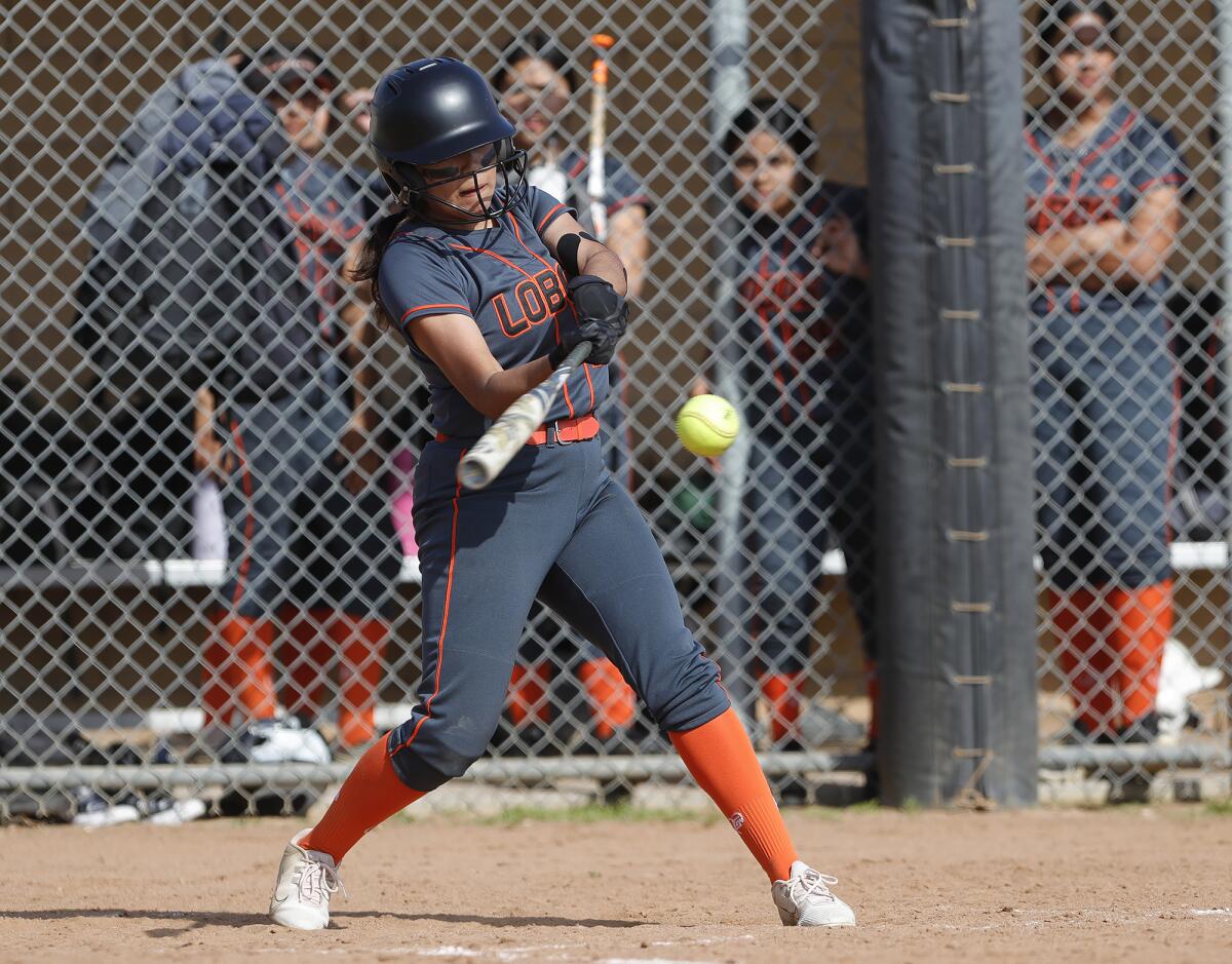 Los Amigos batter Maria Castillo (11) hits a single during a Garden Grove League softball game against Loara on Friday.