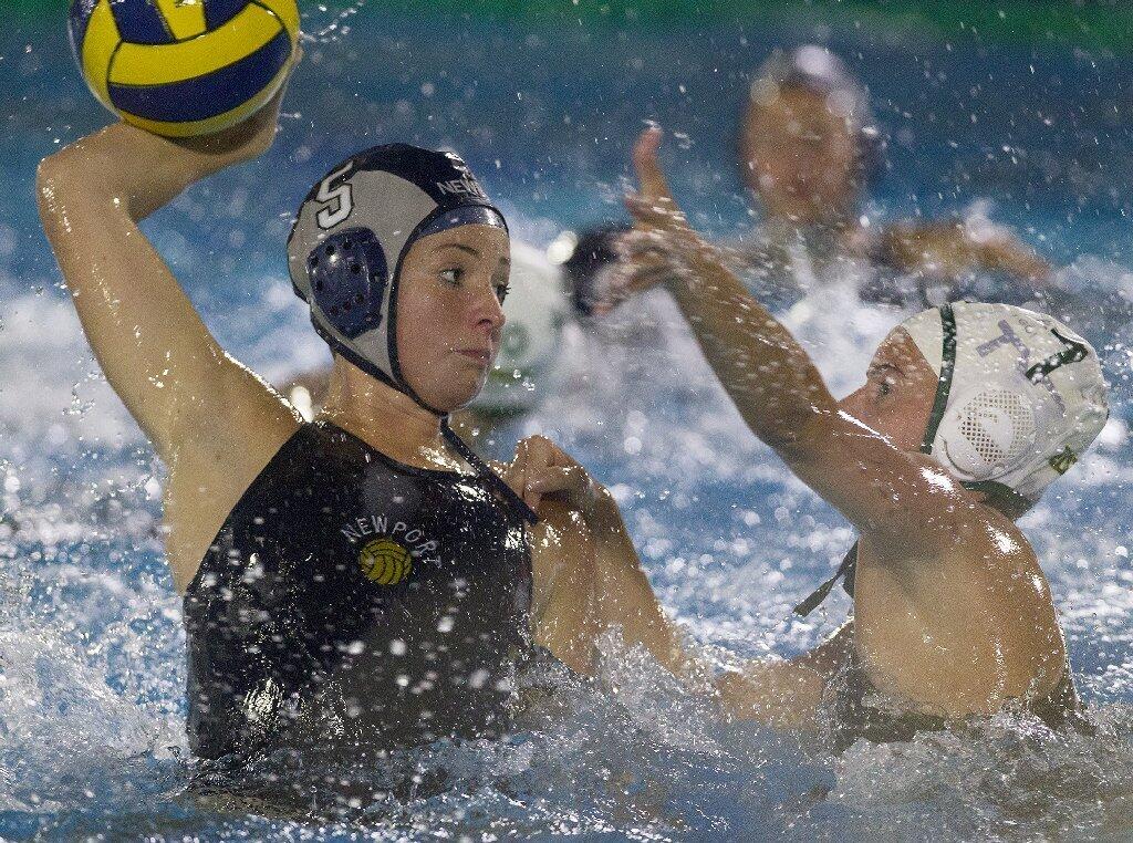 Newport Harbor High's Sarah Barker (5) battles against Edison's Bree Marmion during the second half in a Sunset League game on Wednesday.