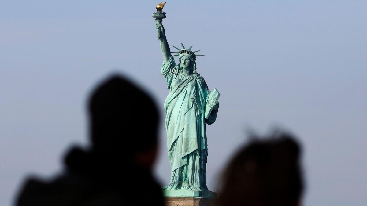 Tourists ride the Staten Island Ferry to get a view of the Statue of Liberty in New York City on Jan. 21.