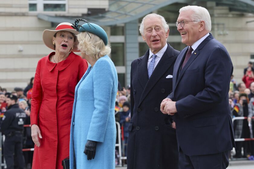 German President Frank-Walter Steinmeier, right, his wife Elke Buedenbender, left, and Britain's King Charles and Camilla, the Queen Consort attend a welcome ceremony, in Berlin, Germany, March 29, 2023. (Wolfgang Rattay/Pool via AP)