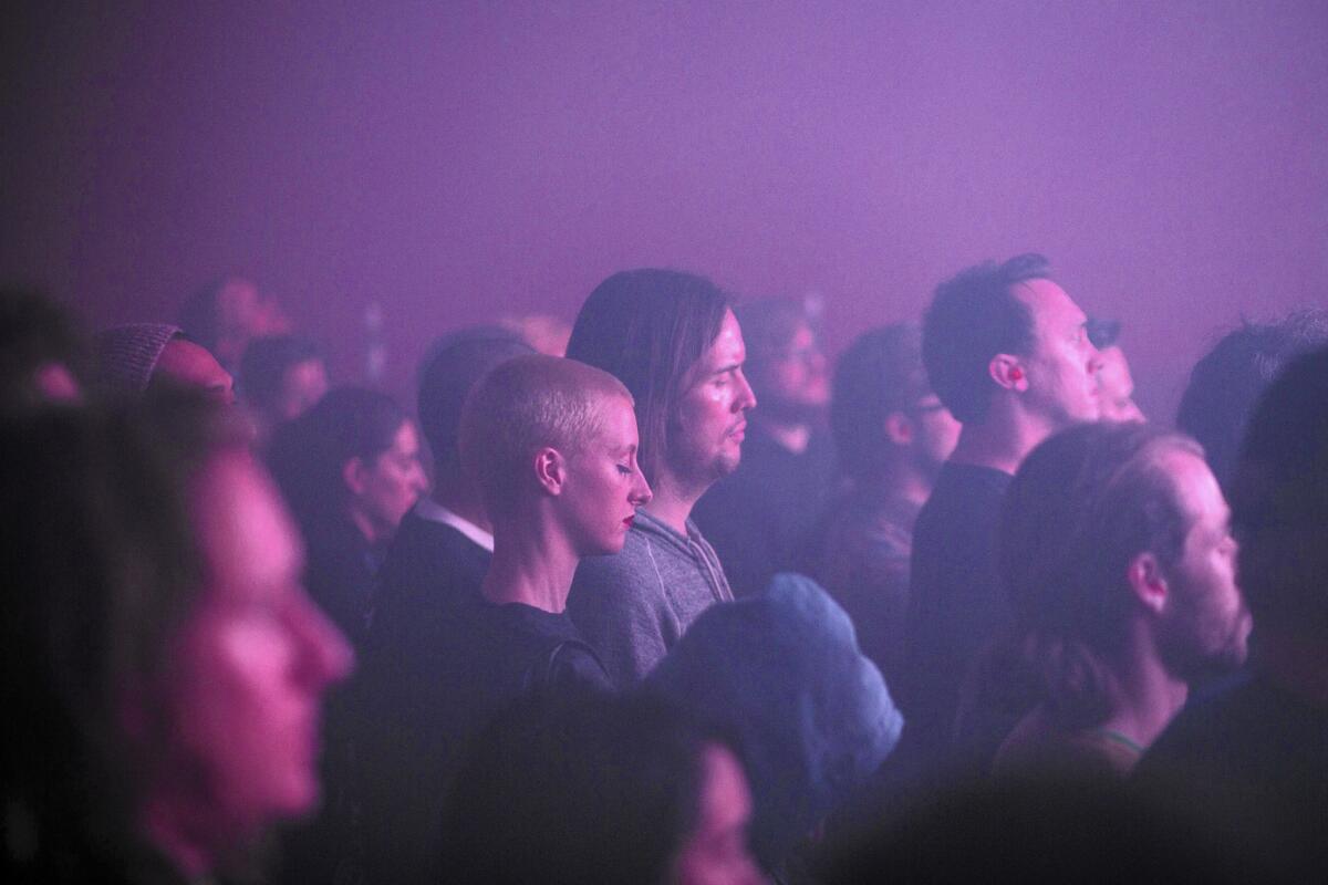The crowd is bathed in colored light during the performance by British musician and record producer Kevin Martin, a.k.a. the Bug, at the Masonic Lodge at Hollywood Forever Cemetery in Hollywood on Dec. 11, 2015.