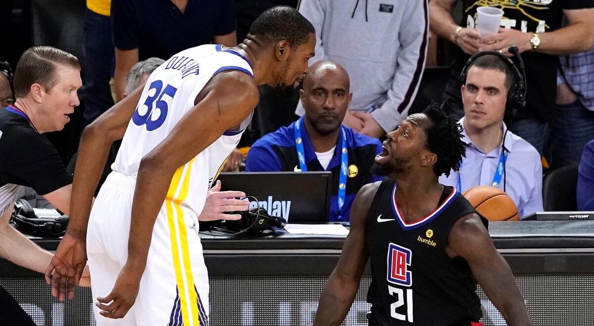 Warriors forward Kevin Durant and Clippers guard Patrick Beverley exchange words moments before they were ejected from Game 1 on Saturday.