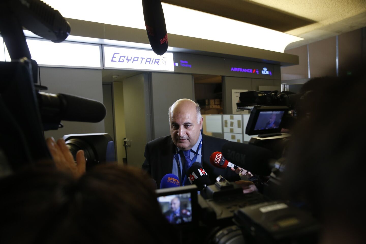 An unidentified employee of EgyptAir speaks to journalists at Charles De Gaulle Airport on May 19, after one of the airline's jets crashed as it traveled from Paris to Cairo.