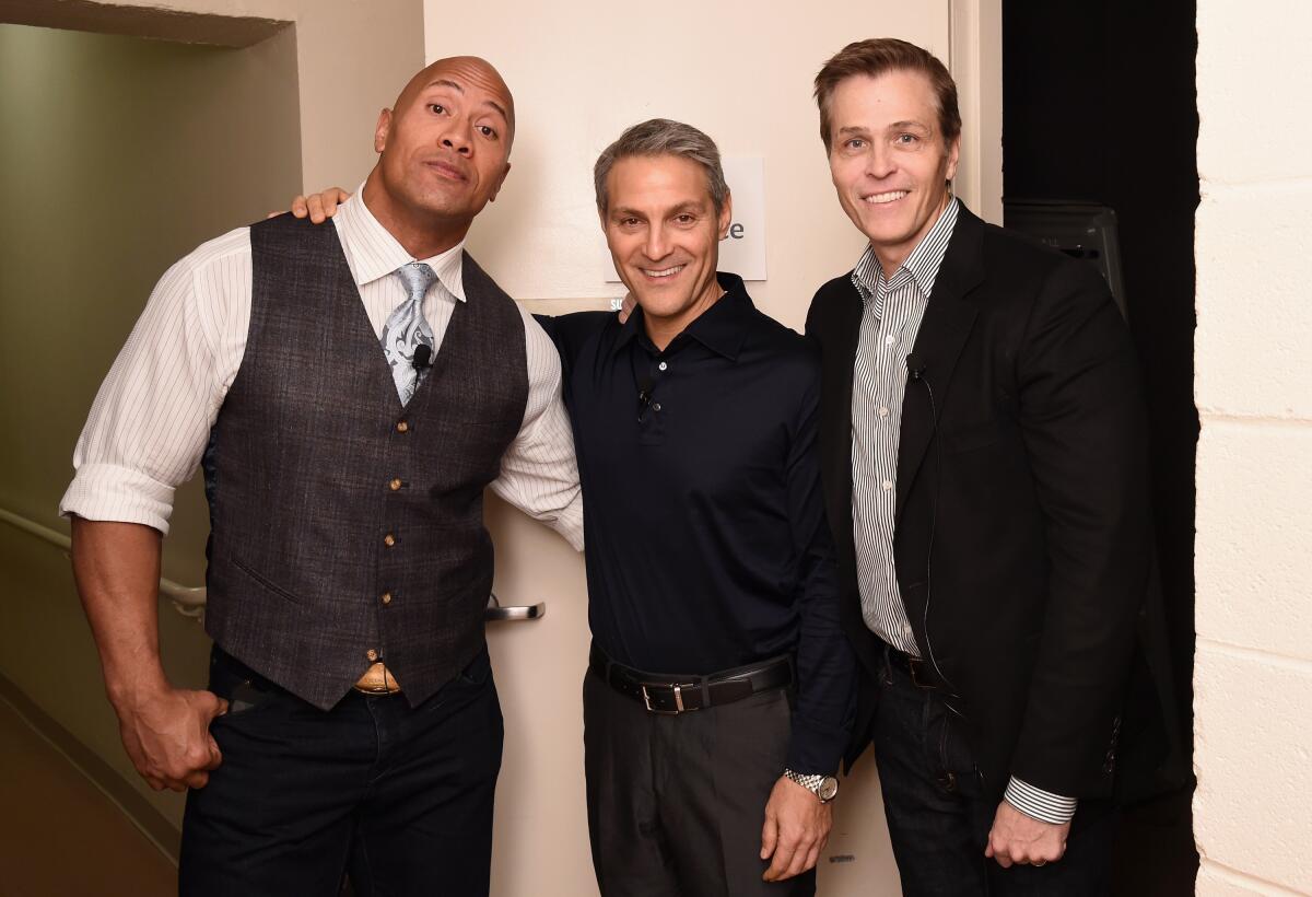 Dwayne "The Rock" Johnson stands with Endeavor's Ari Emanuel and Patrick Whitesell at an event in November 2015.