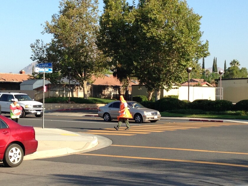 More than a dozen motorists were cited for allegedly failing to see an undercover officer dressed as a giant traffic cone during a pedestrian crossing sting.