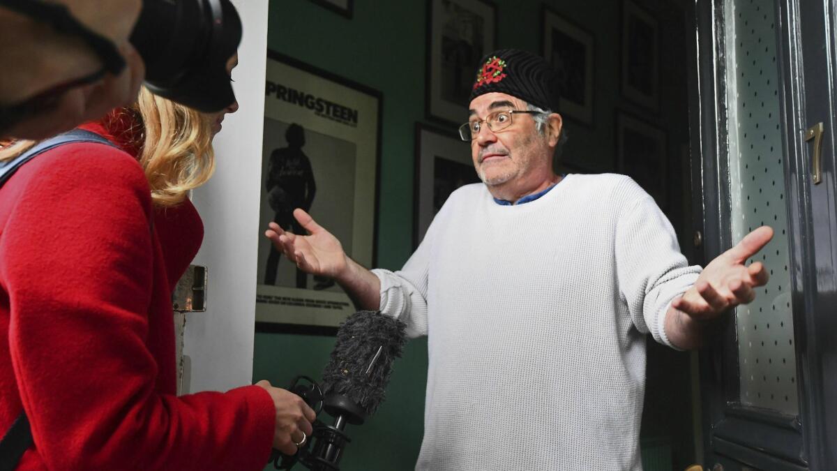 Fired BBC Radio host Danny Baker, right, speaks to the media May 9 at the door of his London home.