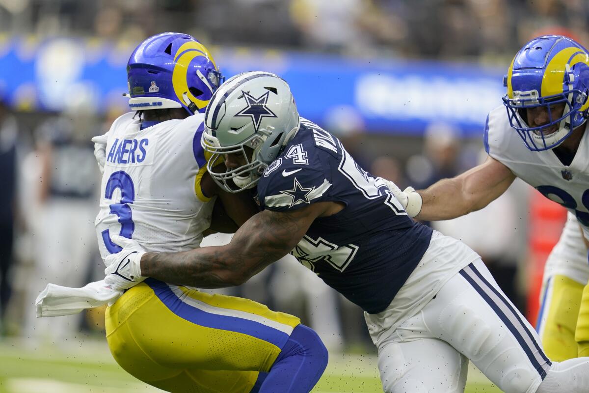  Rams running back Cam Akers (3) is stopped by Cowboys defensive end Sam Williams.