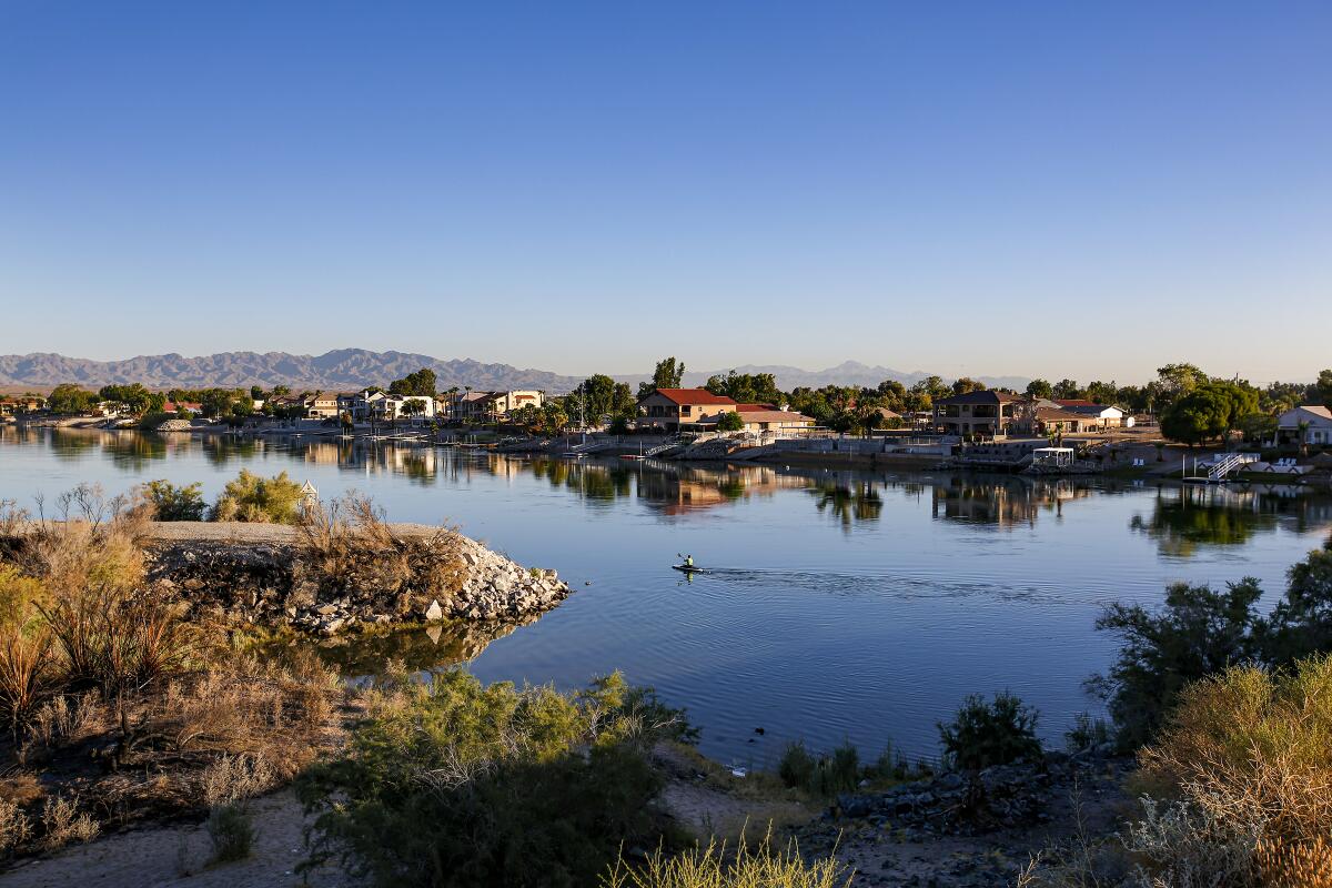 An early morning kayaker paddles on a river