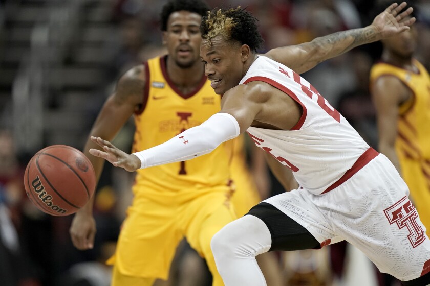 Texas Tech guard Adonis Arms (25) chases a loose ball during the first half of an NCAA college basketball game against Iowa State in the quarterfinal round of the Big 12 Conference tournament in Kansas City, Mo., Thursday, March 10, 2022. (AP Photo/Charlie Riedel)