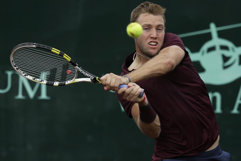 Jack Sock returns a shot against John Isner in the semifinals of the U.S. Men's Clay Court Championship on Saturday.