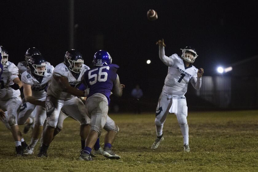 Newport Harbor's Nicholas Kim throws a long pass for a large gain against St. Anthony during a CIF Southern Section Division 9 playoff game at Clark Field in Long Beach on Friday, November 8, 2019. ///ADDITIONAL INFO: tn-dpt-sp-nb-newport-st-anthony-football-20191108 11/8/19 - Photo by DREW A. KELLEY, CONTRIBUTING PHOTOGRAPHER