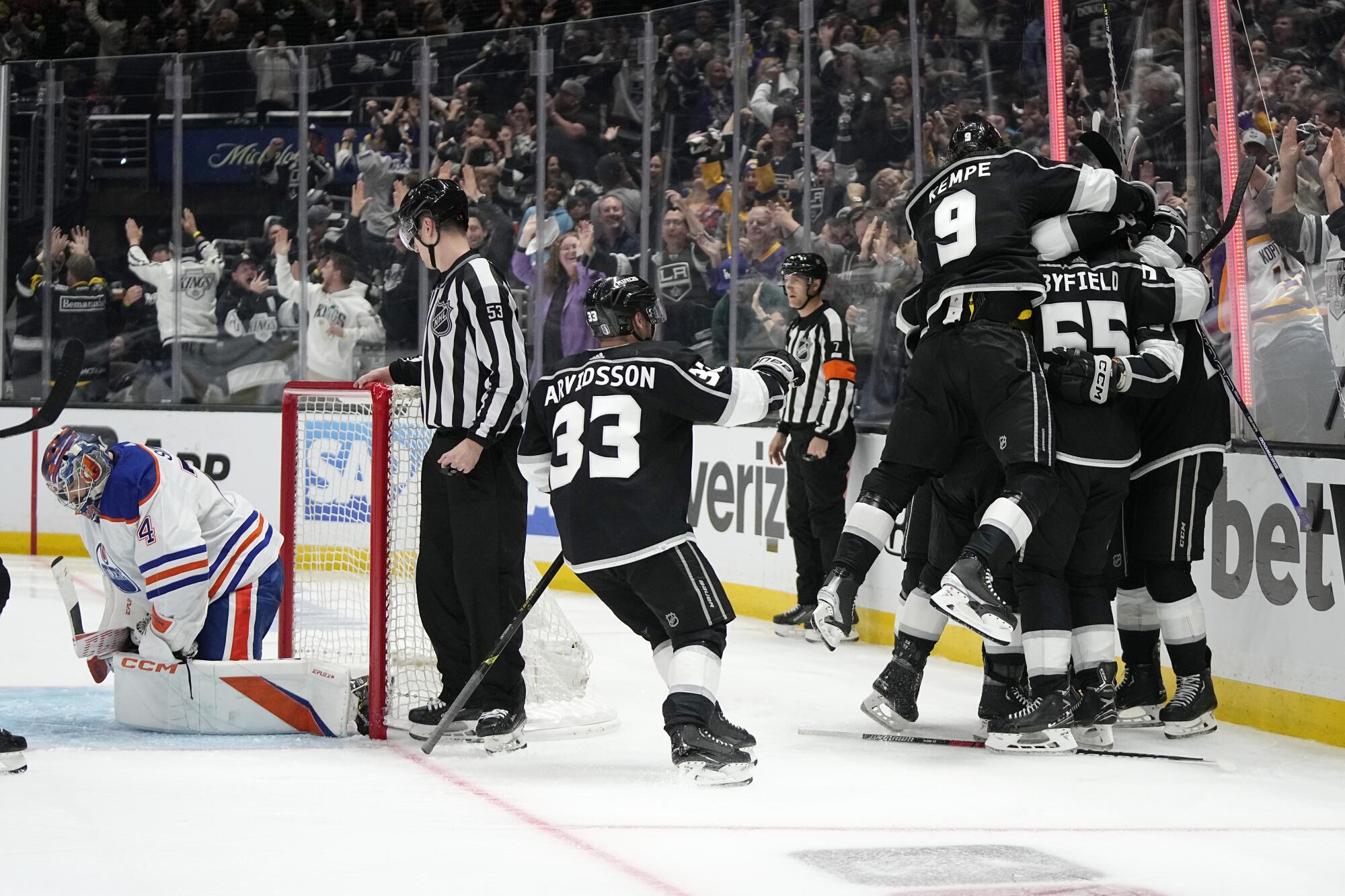 Kings players celebrate after Trevor Moore's winning goal in overtime against the Edmonton Oilers.
