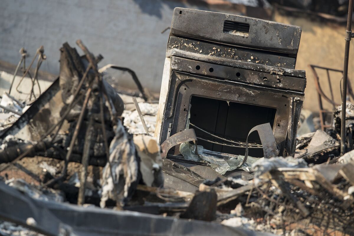 A charred cooking range sits amid the ruins of a home on Hemlock Street in Santa Rosa.