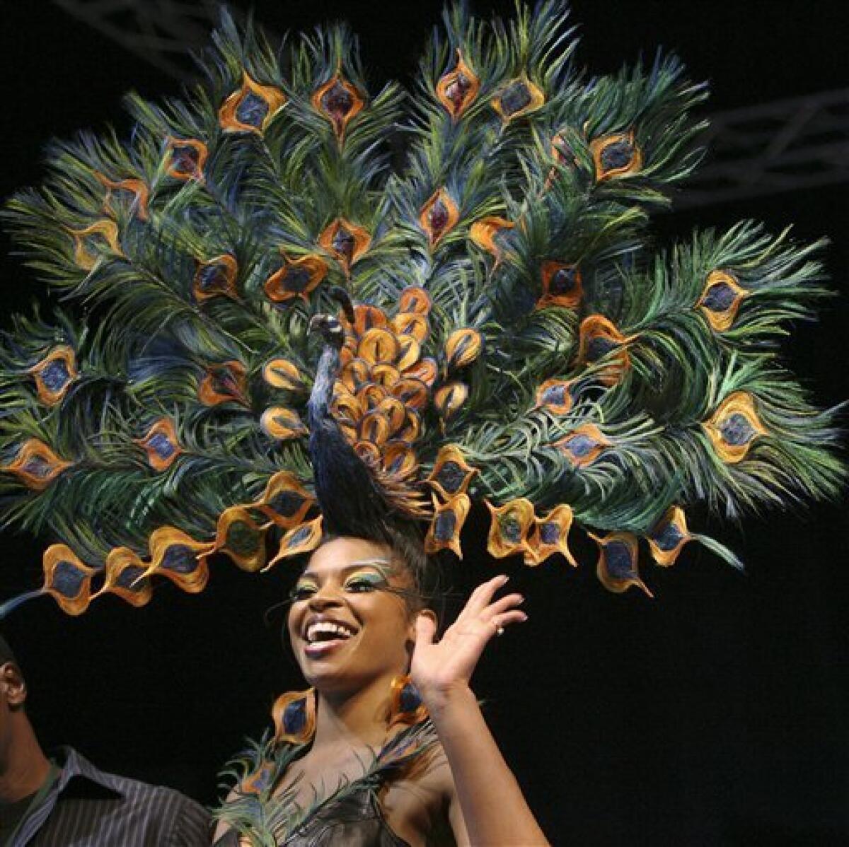 Model Amaris Brown smiles in Manchester, N.H., Thursday, April 23, 2009, after winning the International Fantasy Hair Competition with a hair style called "Proud Peacock" designed by Kevin Carter of The Artistry of Hair from Farmington Hills, Mich. (AP Photo/Jim Cole)