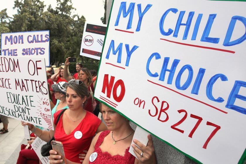FILE - In this June 9, 2015, file photo, Karman Willmer, left, and Shelby Messenger rally against SB 277, a California measure requiring schoolchildren to get vaccinated, outside the Capitol in Sacramento, Calif. California's Assembly on Thursday, June 25, 2015, approved a hotly contested bill requiring that nearly all public schoolchildren be vaccinated, clearing one of its last major legislative obstacles before the measure heads to the desk of Gov. Jerry Brown. The bill aims to increase immunization rates after a measles outbreak linked to Disneyland in December sickened over 100 people in the U.S. and Mexico. (AP Photo/Rich Pedroncelli, File) ORG XMIT: LA113