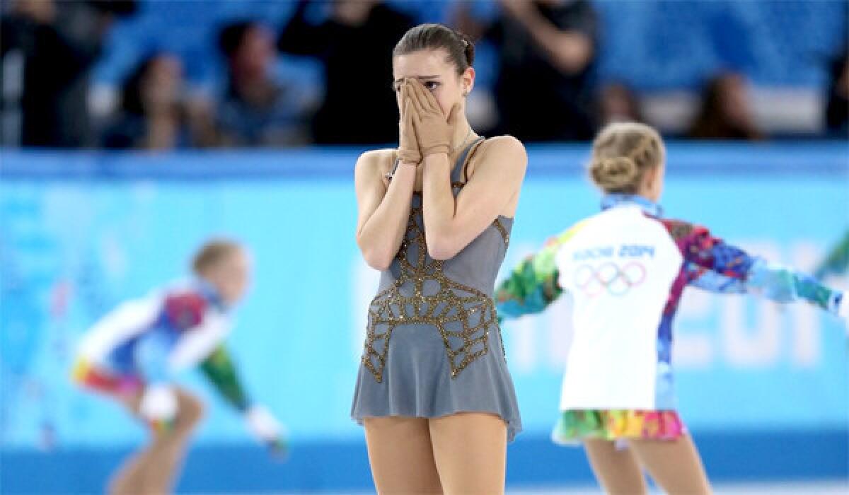 And emotional Adelina Sotnikova of Russia reacts after her gold medal winning performance during the ladies' free skate Thursday at Iceberg Skating Palace.