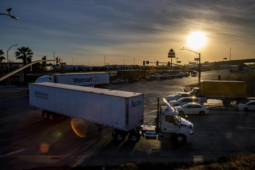 JURUPA VALLEY, CA - APRIL 30, 2021: Diesel truck traffic has increased with the addition of more giant warehouses being built nearby at the intersection of Van Buren Boulevard and Etiwanda Avenue on April 30, 2021 in Jurupa Valley, California. The diesel truck traffic is causing more air pollution in the Southland.(Gina Ferazzi / Los Angeles Times)