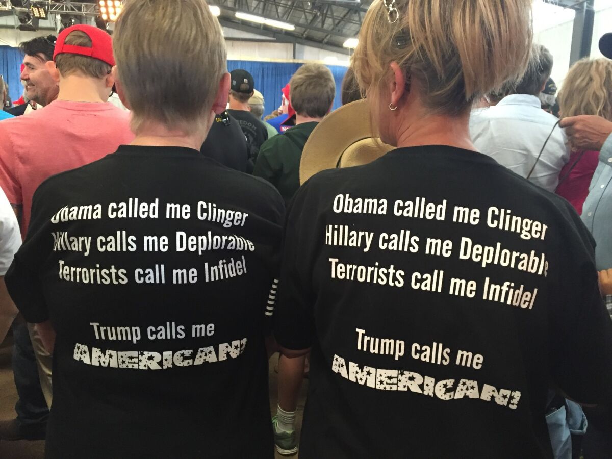 Neighbors Kathy Smith and Tina Griffiths wear matching Trump T-shirts at a rally in Colorado. (Lisa Mascaro / Los Angeles Times)