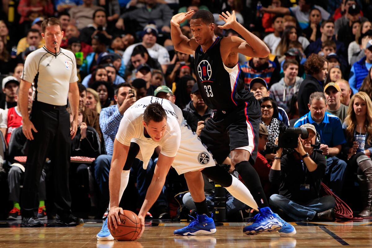 Clippers guard Wesley Johnson guards Nuggets forward Danilo Gallinari during a game in Denver on Nov. 24.