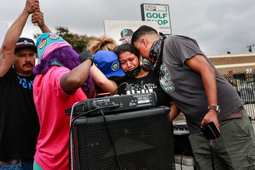 GARDENA, CA - JUNE 28: Jennifer Guardado, sister of Andres Guardado, who was fatally shot by a sheriff's deputy in Gardena, and other relatives of speak at the rally seeking justice for Andres Guardado on Sunday, June 28, 2020 in Gardena, CA. (Jason Armond / Los Angeles Times)