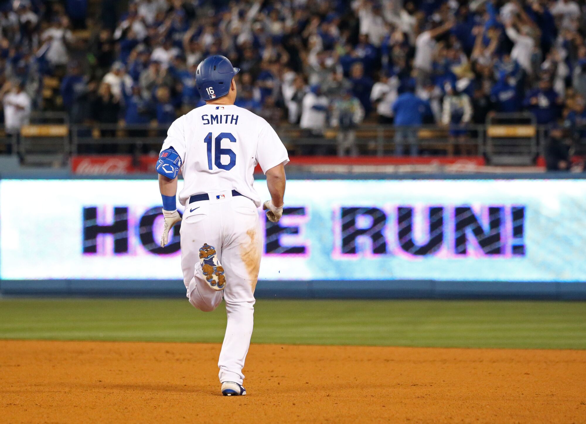 Dodgers catcher Will Smith circles the bases after hitting a three-run home run in the eighth inning.