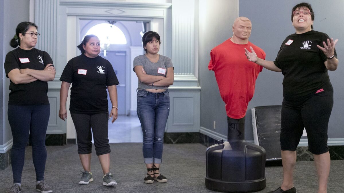 Lilia García-Brower, 45, right, executive director of the Maintenance Cooperation Trust, leads self-defense training for janitors.
